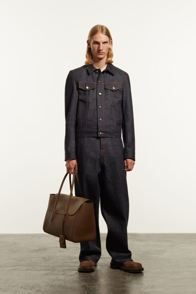 A relaxed fit blue denim jacket with long sleeves paired with wide-leg denim pants.