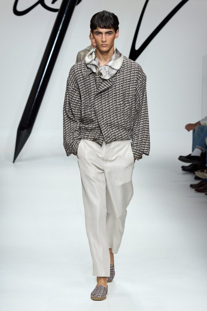 A relaxed gray checked jacket paired with beige pants, featuring a collared neckline.