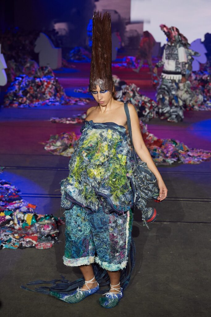 A relaxed multicolor denim sleeveless jumpsuit with a layered design.