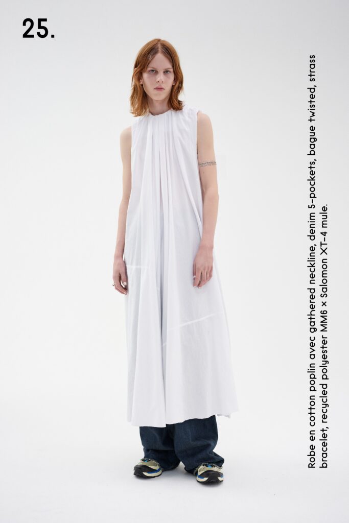 A relaxed white sleeveless dress with a high neckline and tiered design.