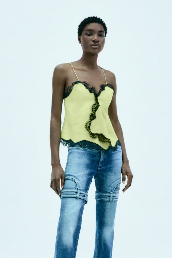 yellow silk ruffled top and blue denim pants