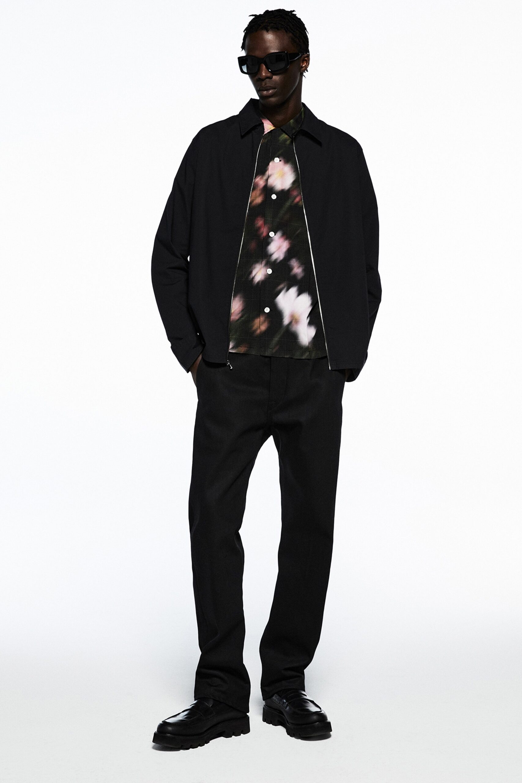 A relaxed black jacket with a collared neckline paired with matching pants.