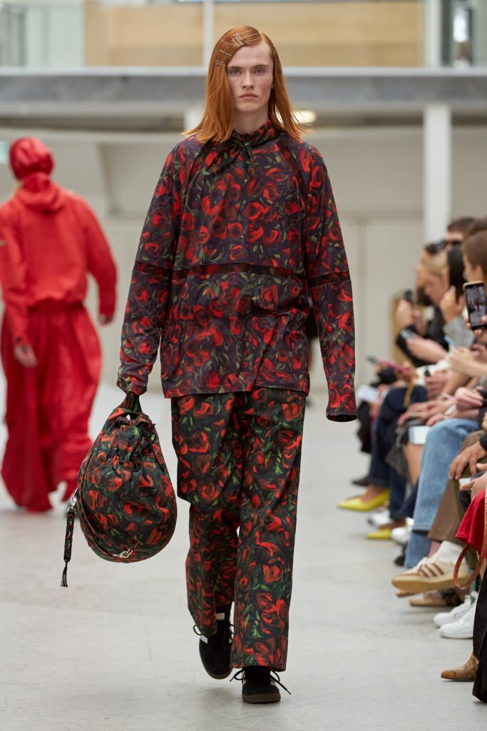 A relaxed fit red and green printed jacket paired with matching pants, featuring a long-sleeve design.
