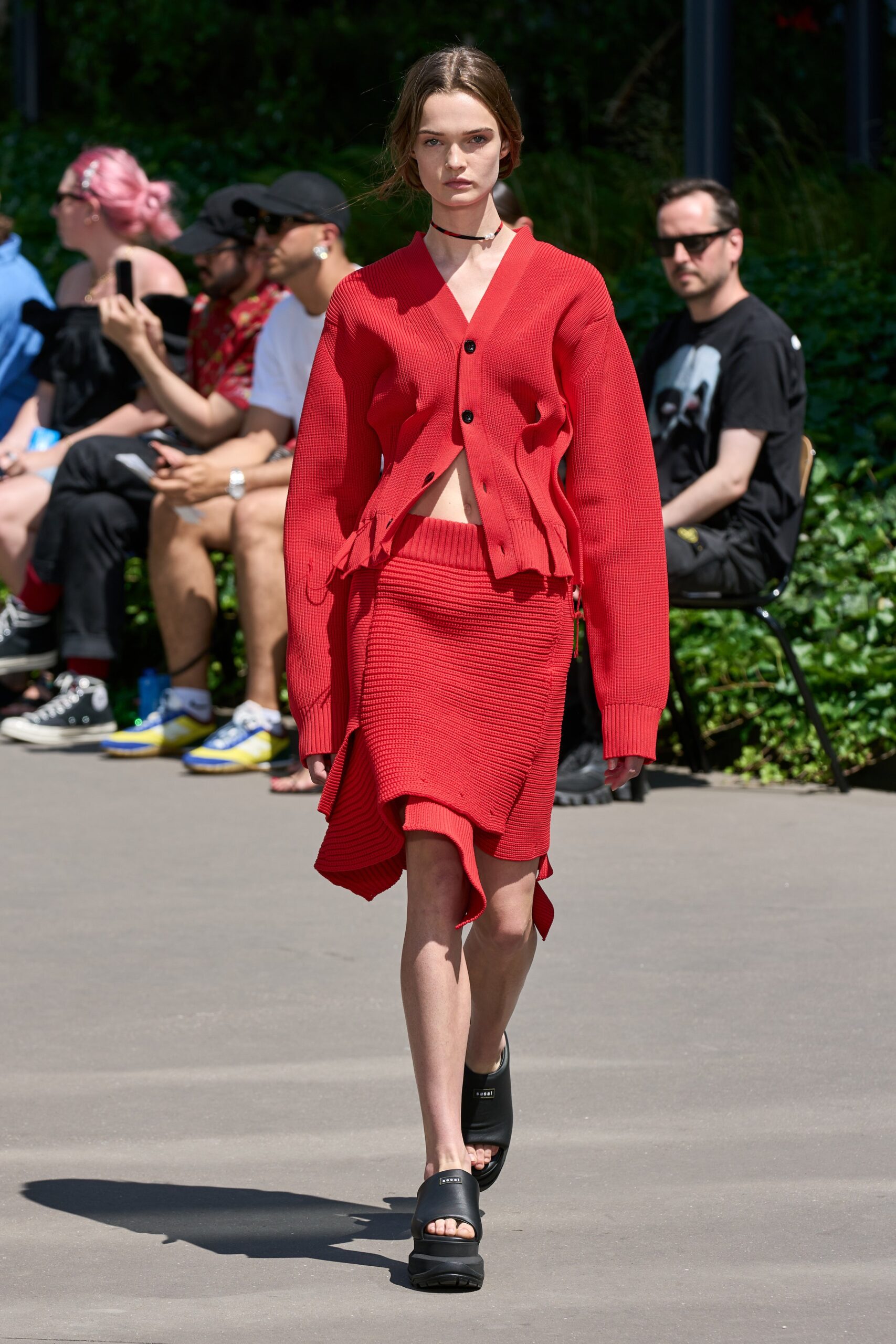 red oversized cardigan and mini skirt