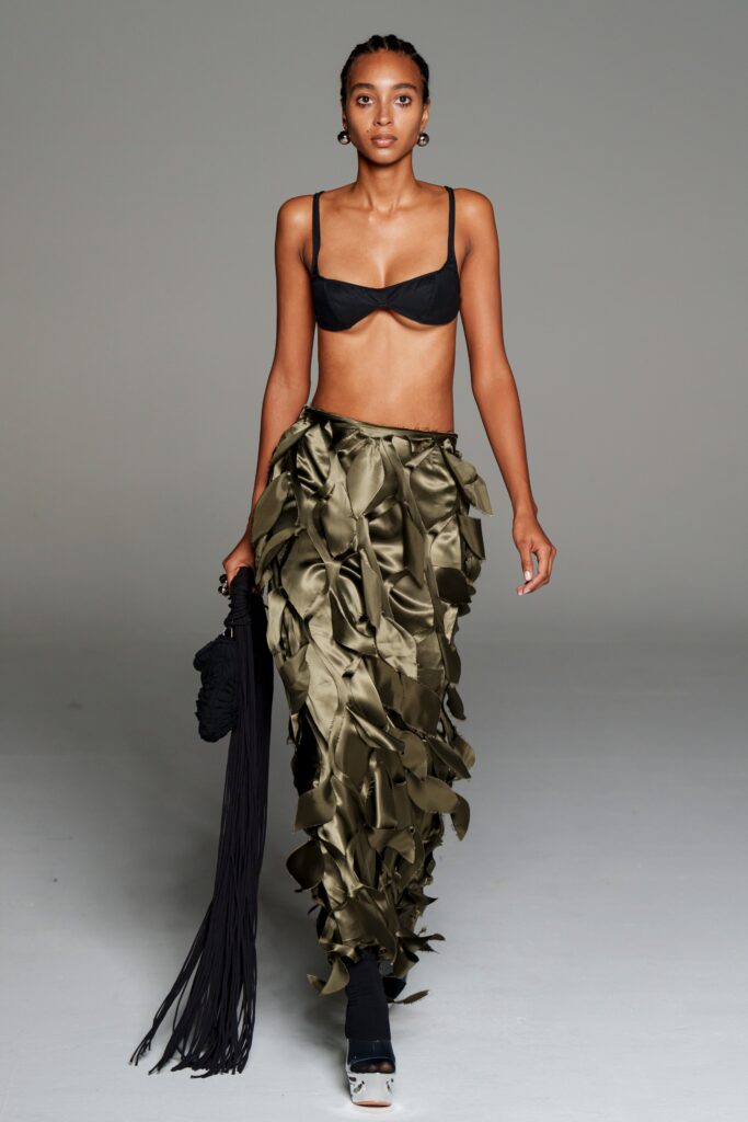 black bra and olive ruffled skirt