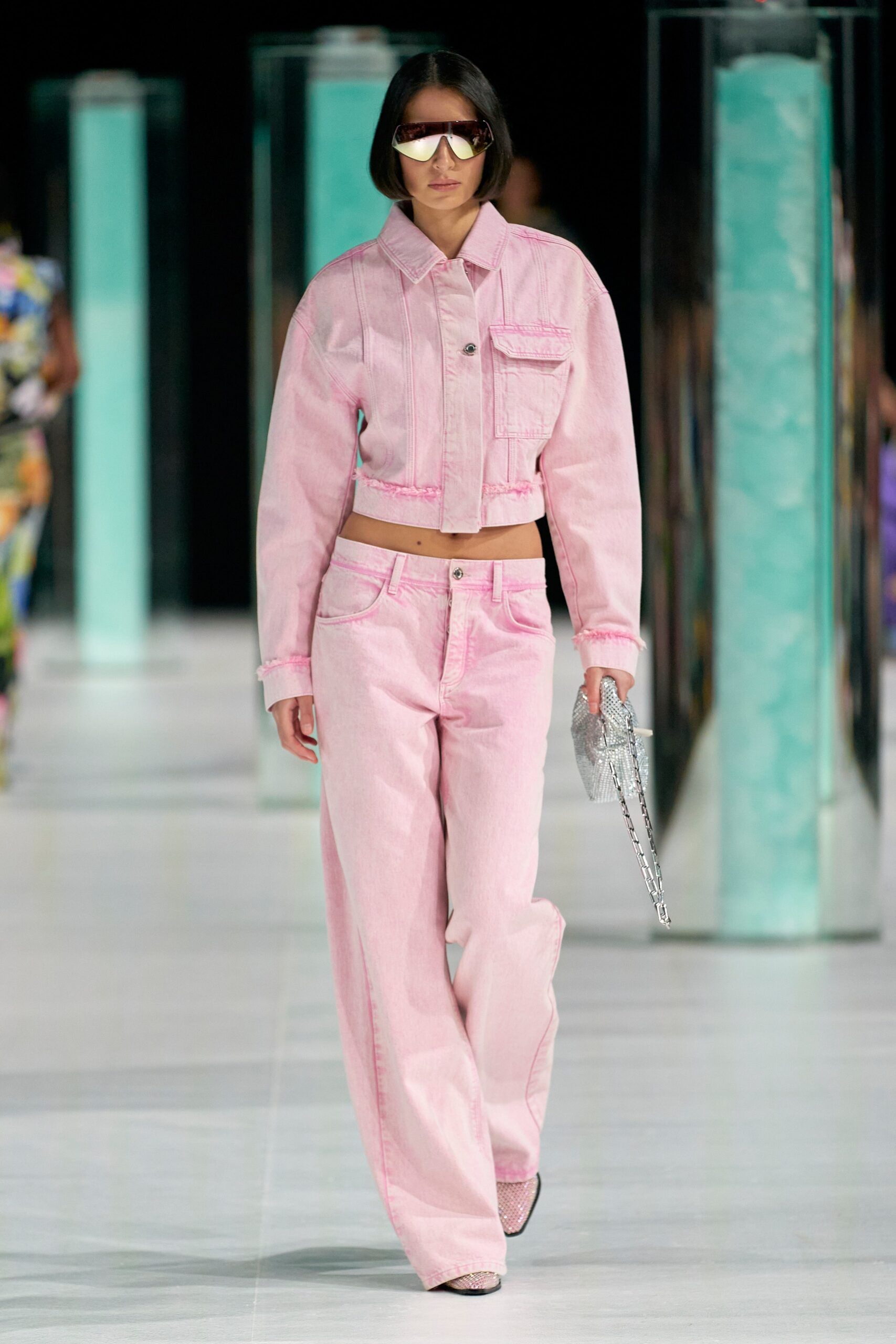 A relaxed pink denim jacket with long sleeves paired with wide-leg pink denim pants.