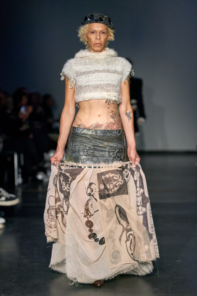 A fitted sleeveless top and asymmetric layered skirt in black and beige.