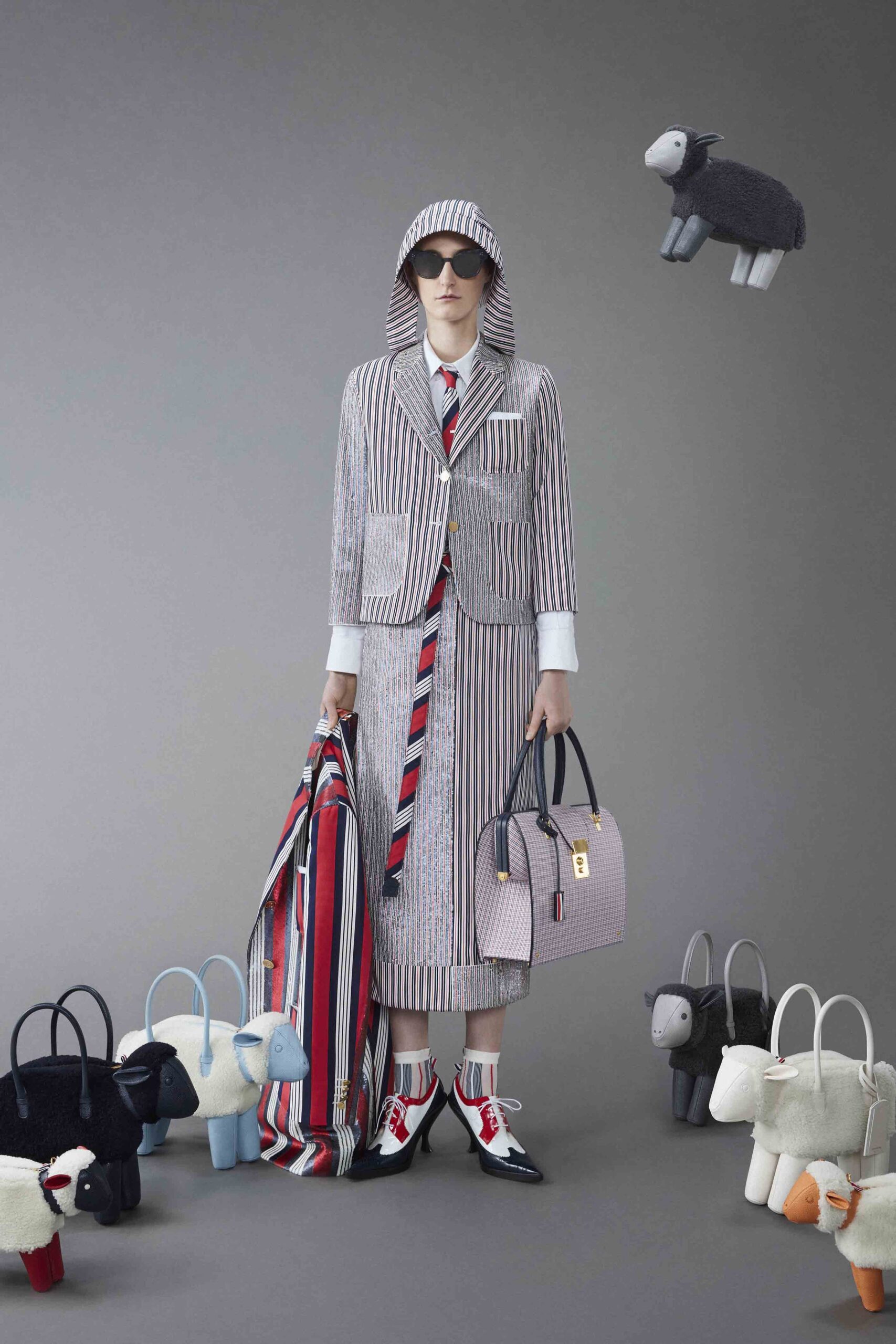 A tailored striped suit in white, blue, and red with a collared long-sleeve design.