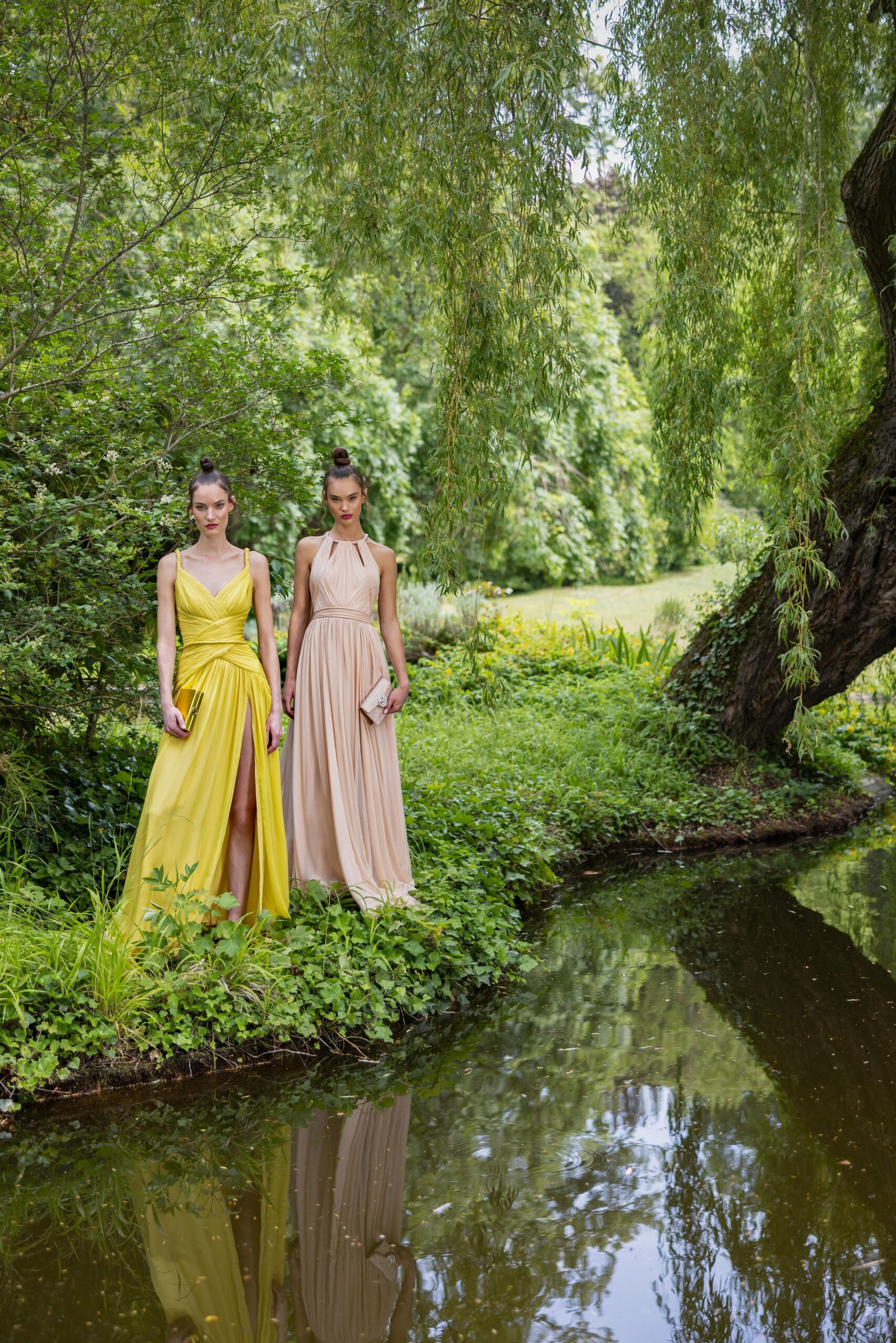 Two fitted dresses, one yellow with a slit and one beige, both featuring a sleeveless V-neck design.