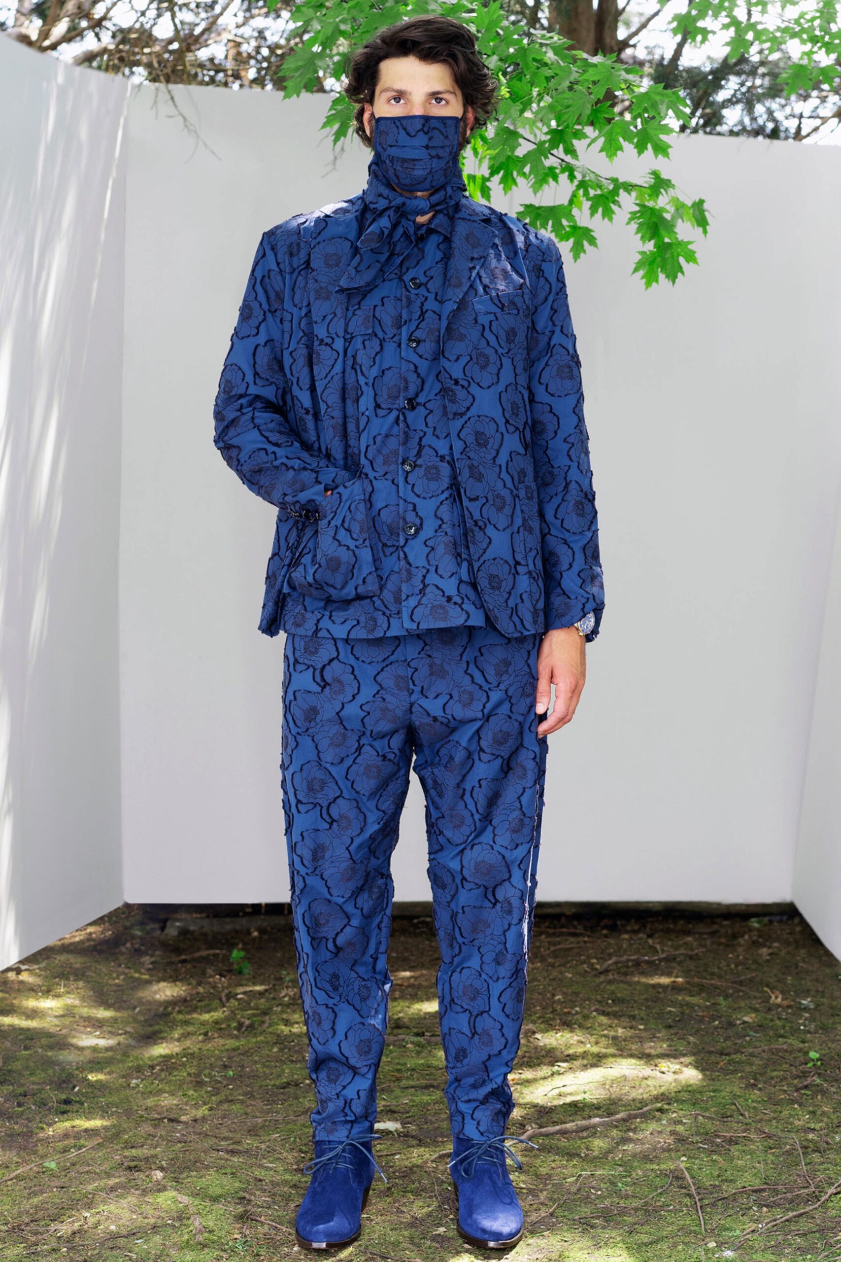 A relaxed blue cotton suit with long sleeves and a collared design featuring a printed pattern.