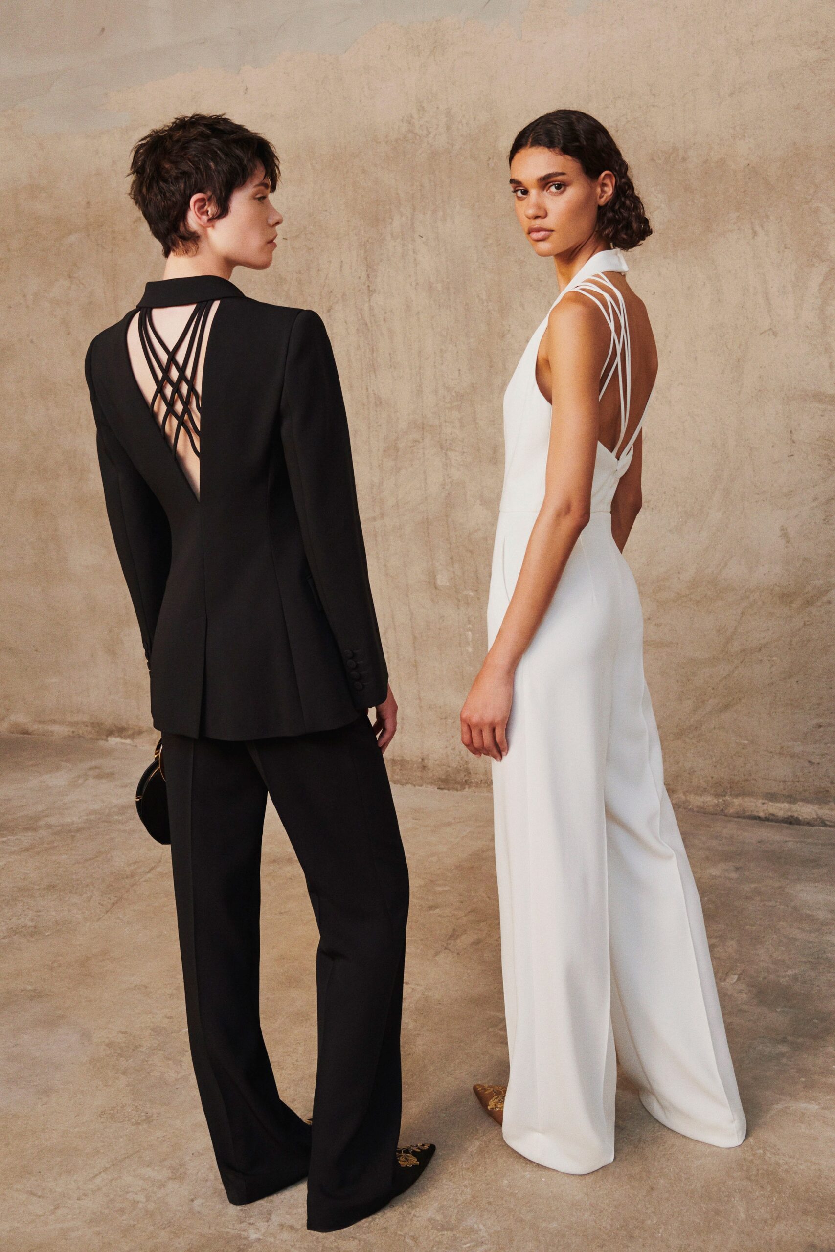black tailored suit and white jumpsuit