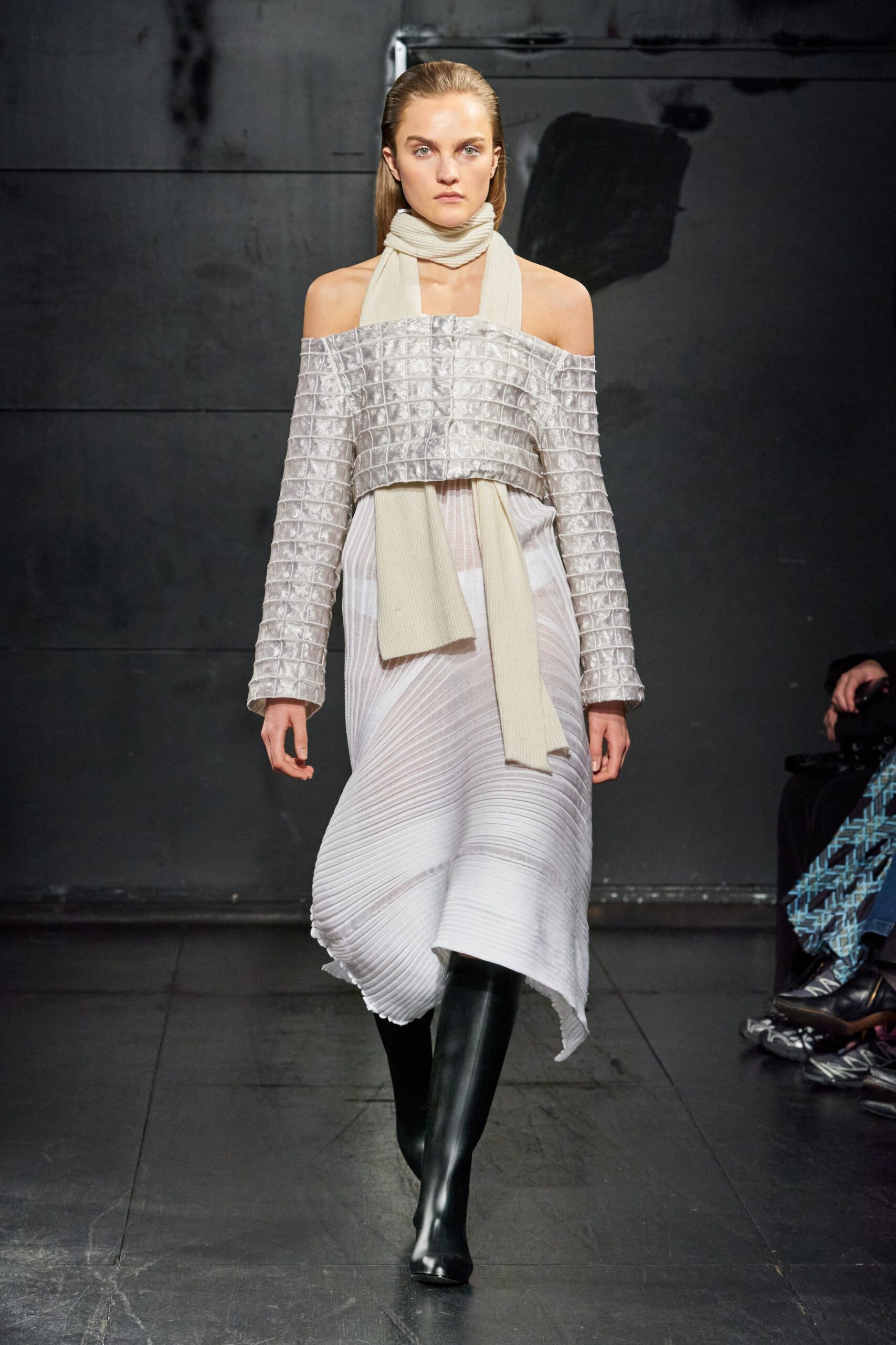 A relaxed white silk off-shoulder dress with pleated and asymmetric design details.
