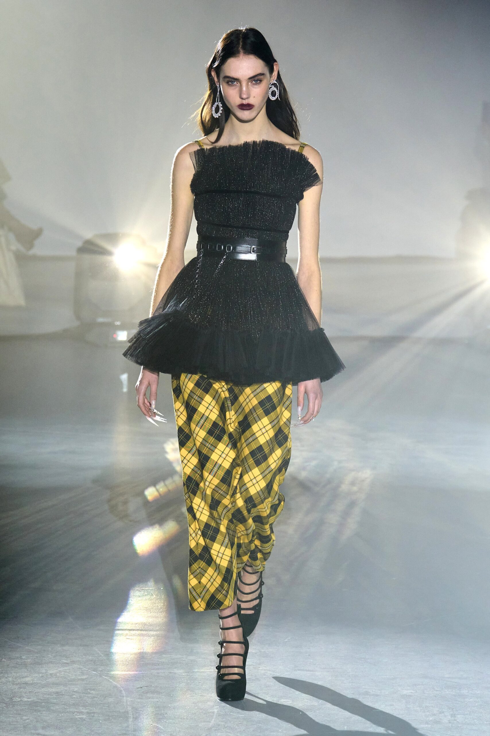 black ruffled top with yellow checked pants