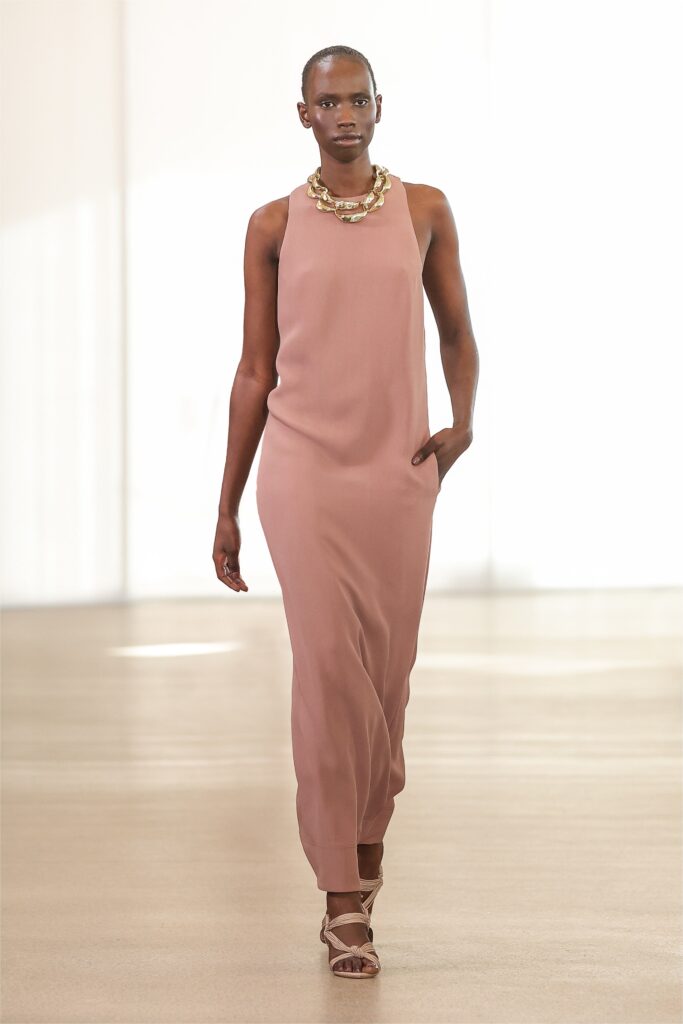 A relaxed pink silk dress with a sleeveless design and high neckline.
