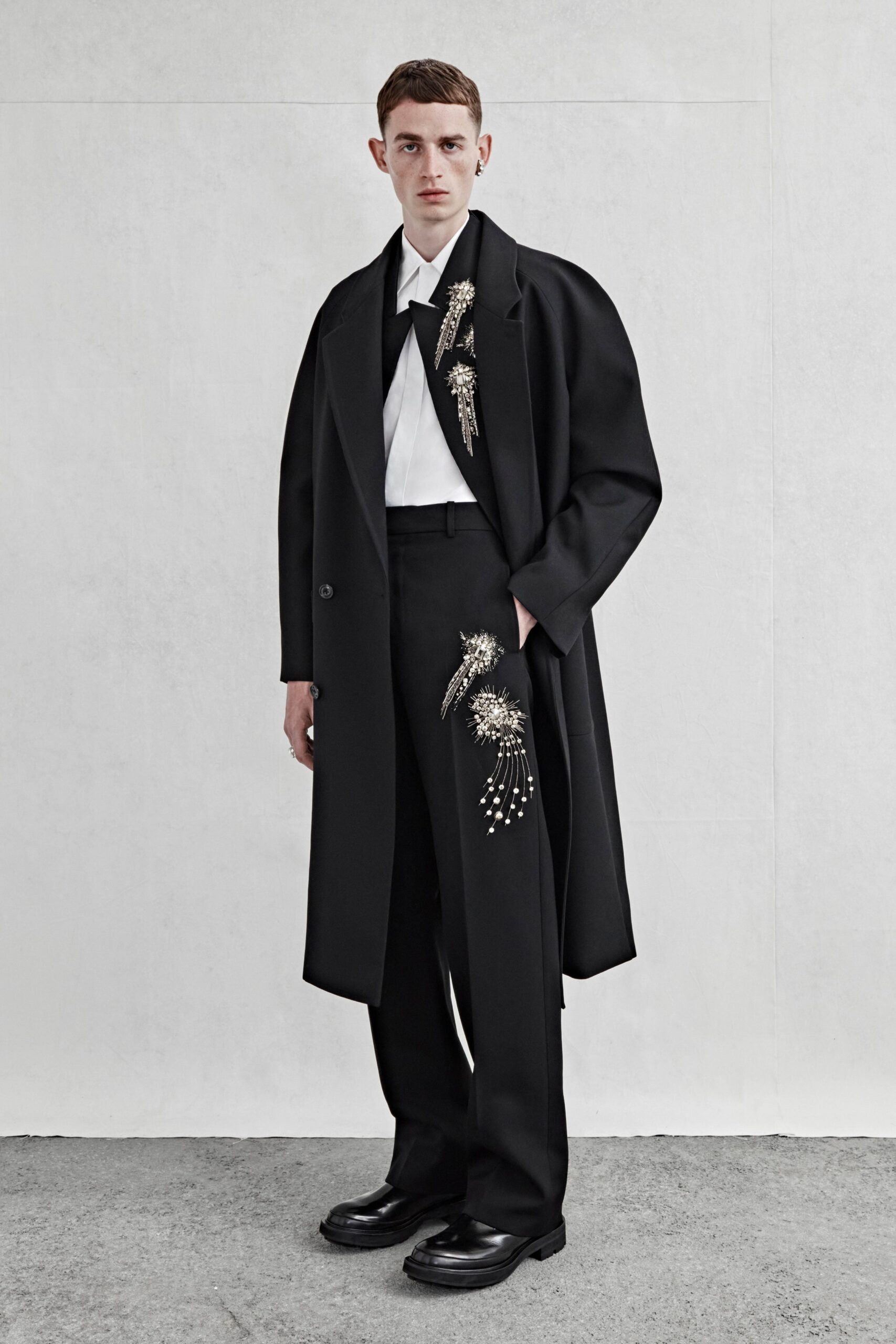 black wool coat with embroidered scarf