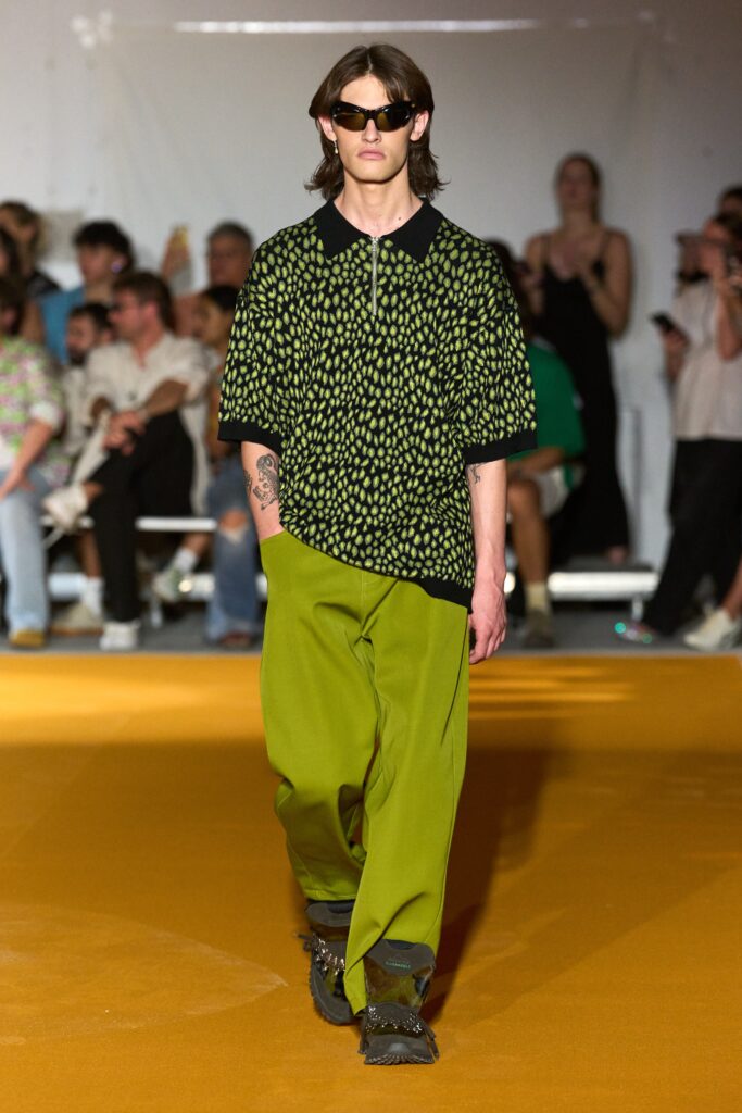 A relaxed black printed shirt paired with green pants, perfect for a casual yet stylish look.