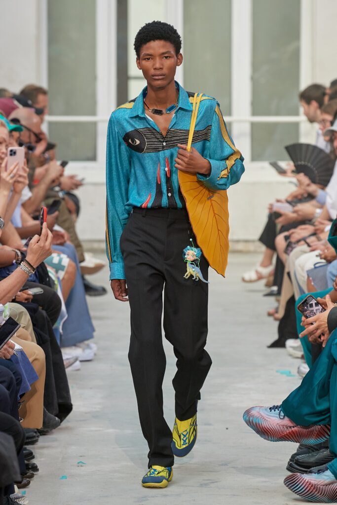 A fitted blue striped long-sleeve shirt paired with black fitted pants.