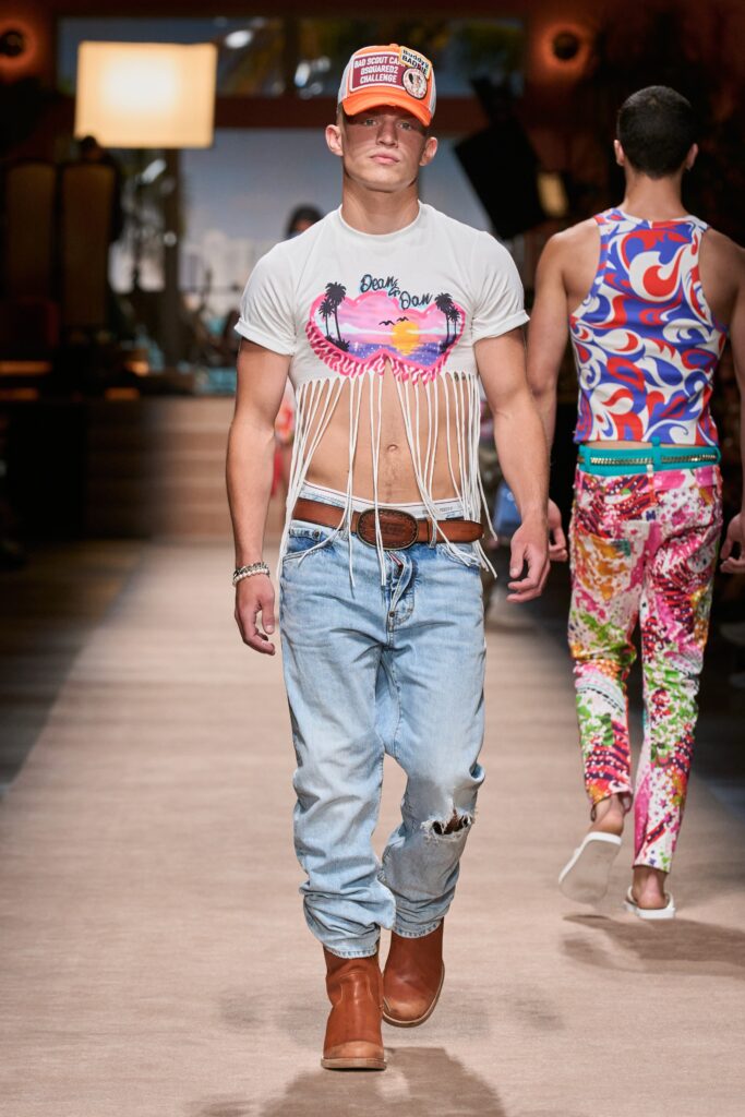 A fitted white printed t-shirt paired with distressed blue jeans for a casual look.