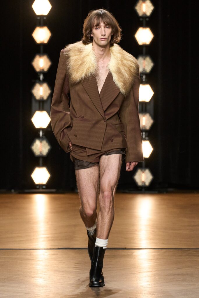 An oversized brown striped jacket with a collared neckline and fur detail.