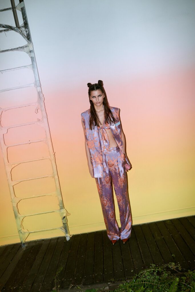 A relaxed purple silk sleeveless top paired with matching pants featuring a printed design.