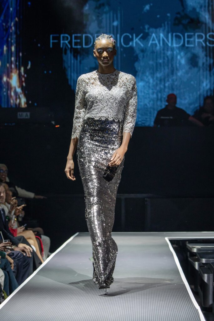 A fitted silver sequin gown with long sleeves and a high neckline, creating a sleek silhouette.