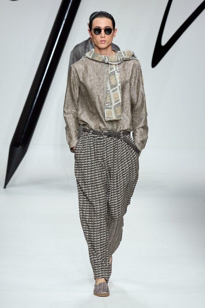 A relaxed long-sleeve collared shirt paired with printed pants in brown and beige tones.