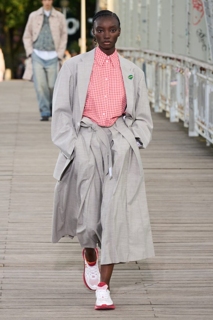 A relaxed gray dress with long sleeves, a collared neckline, and pleated details.