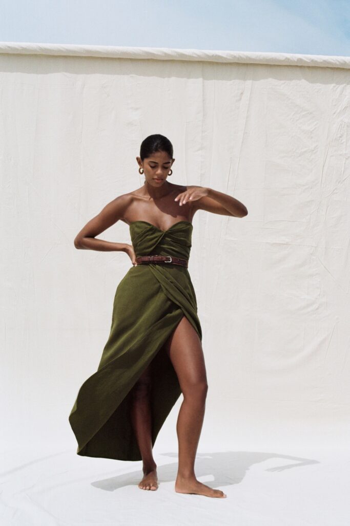 A fitted green silk strapless dress with a high slit for a dramatic effect.