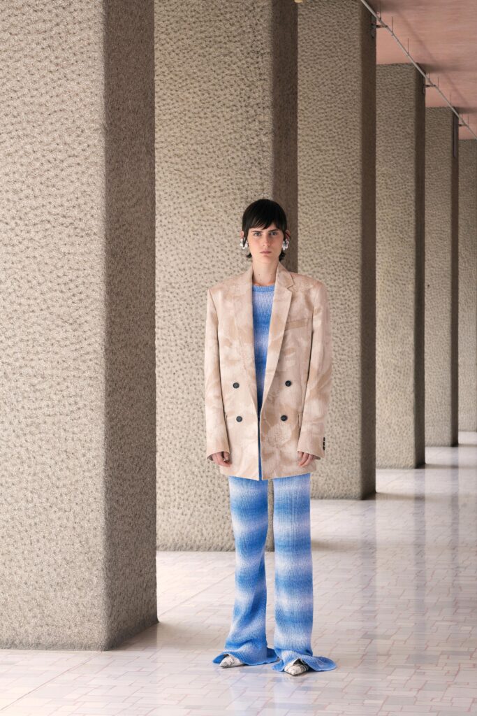 beige tailored blazer with blue flared pants