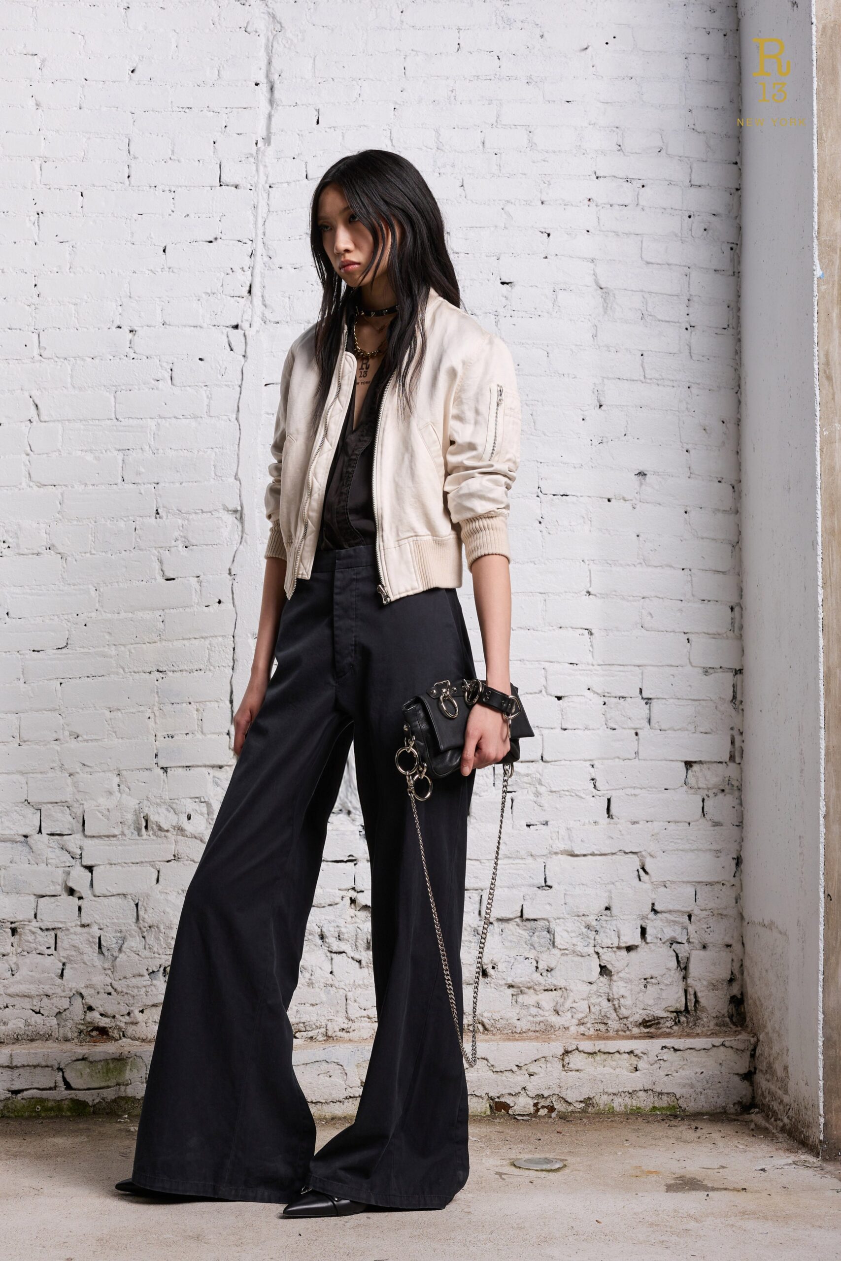 A relaxed white long-sleeve jacket paired with wide-leg black pants.