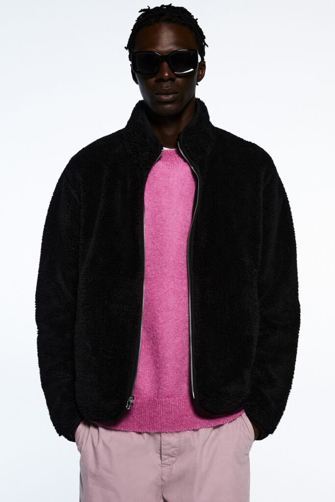 black faux-fur jacket with pink sweater