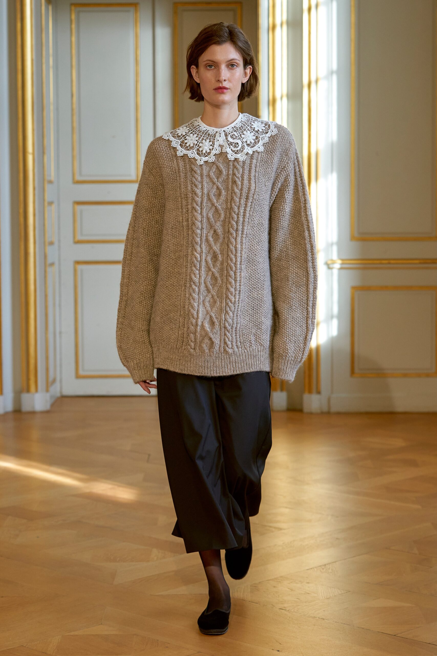 beige oversized knitted sweater and black relaxed pants