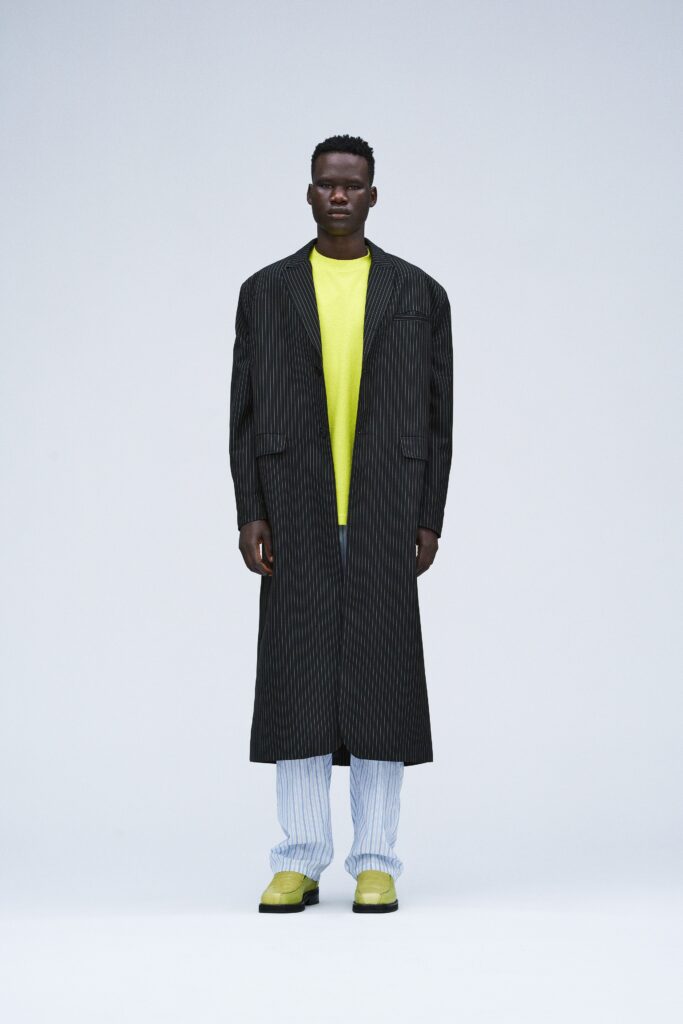 black striped coat with yellow t-shirt