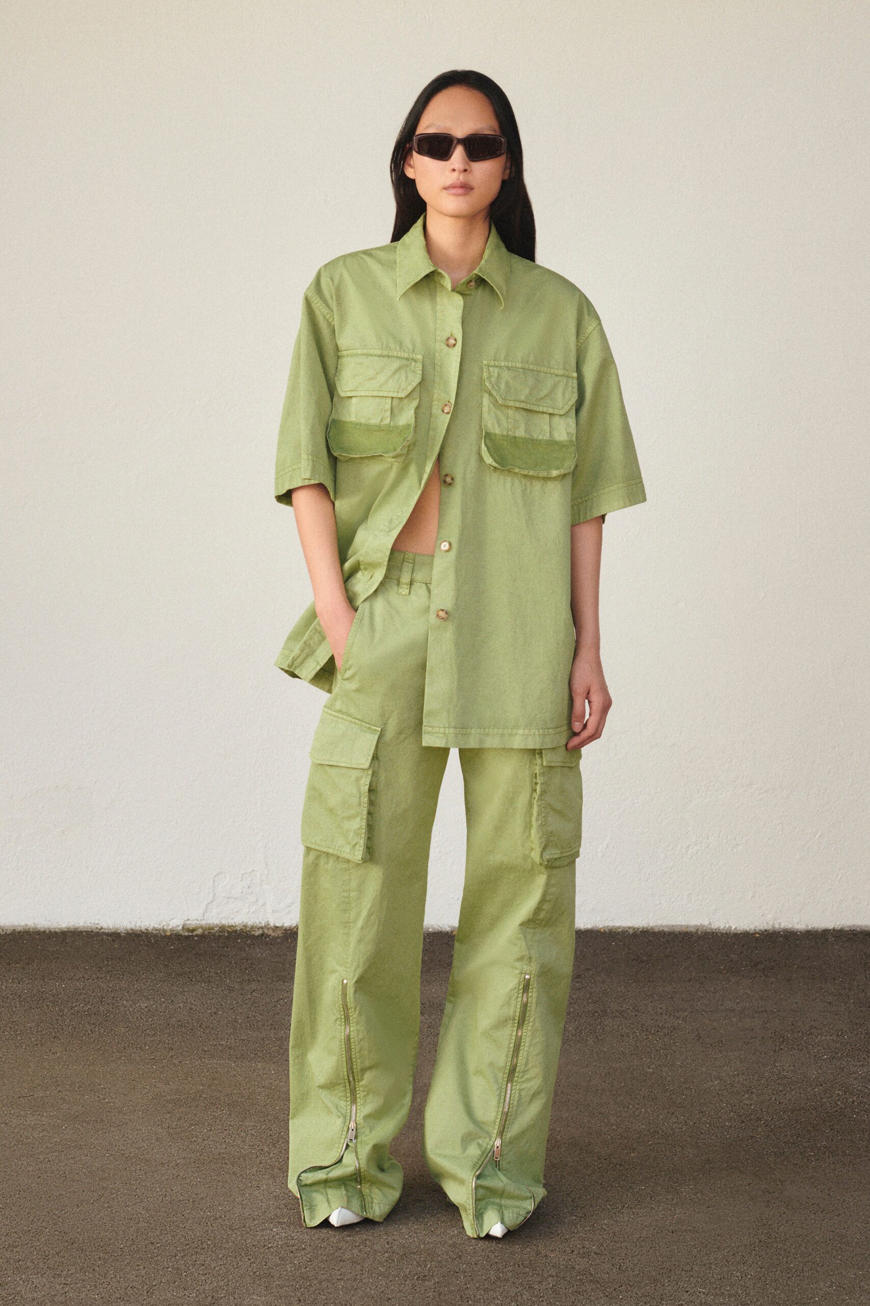 A relaxed green shirt with short sleeves and cargo pants, featuring a collared design.