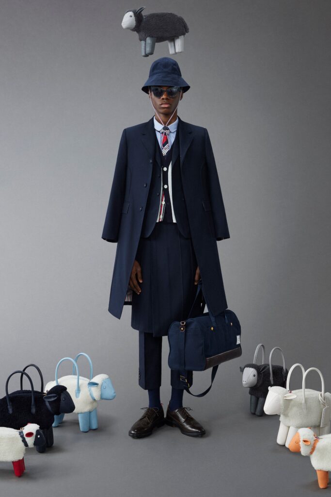 A tailored navy wool coat paired with a vest featuring a pleated design.