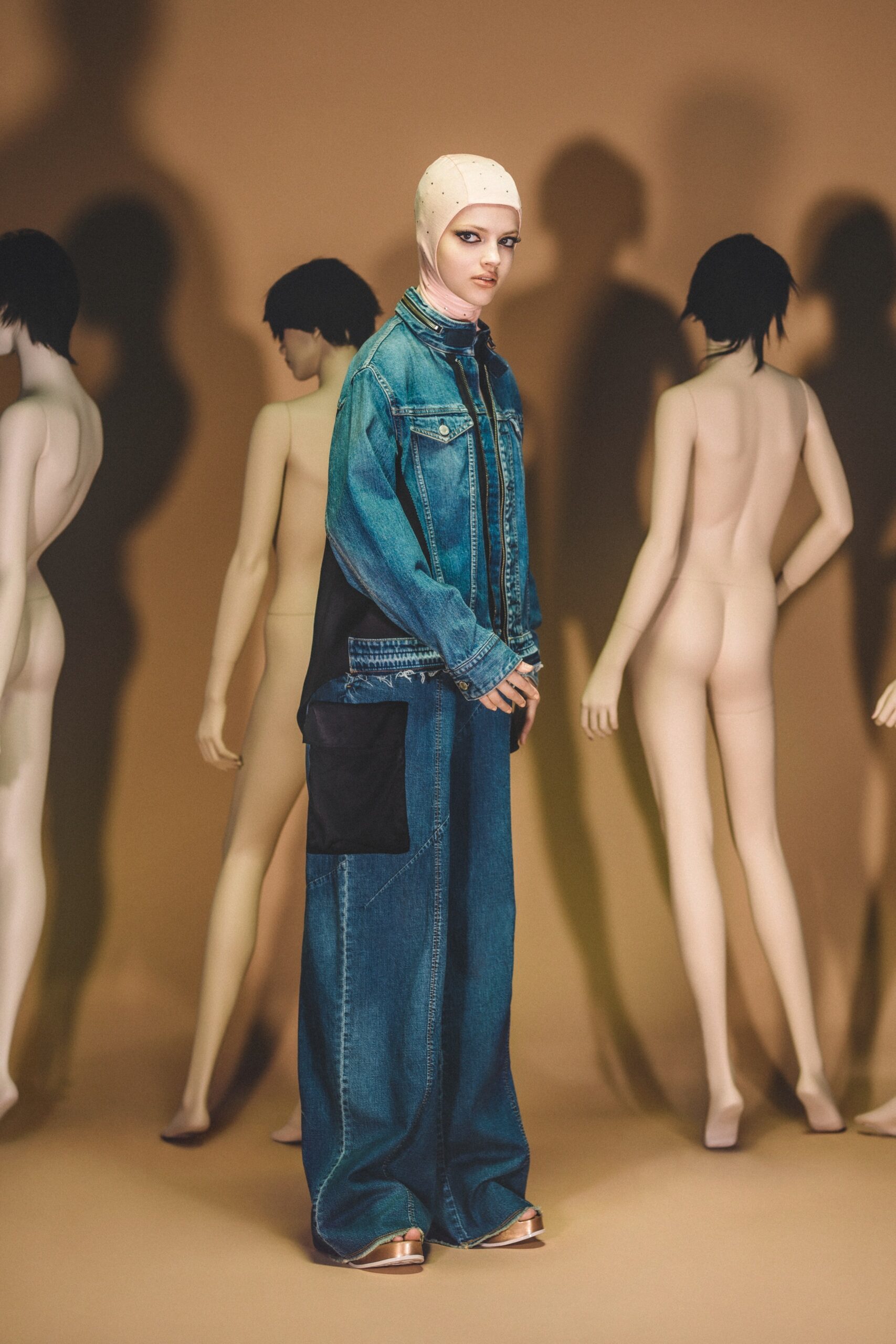 A relaxed blue denim jacket with long sleeves paired with wide-leg denim pants.