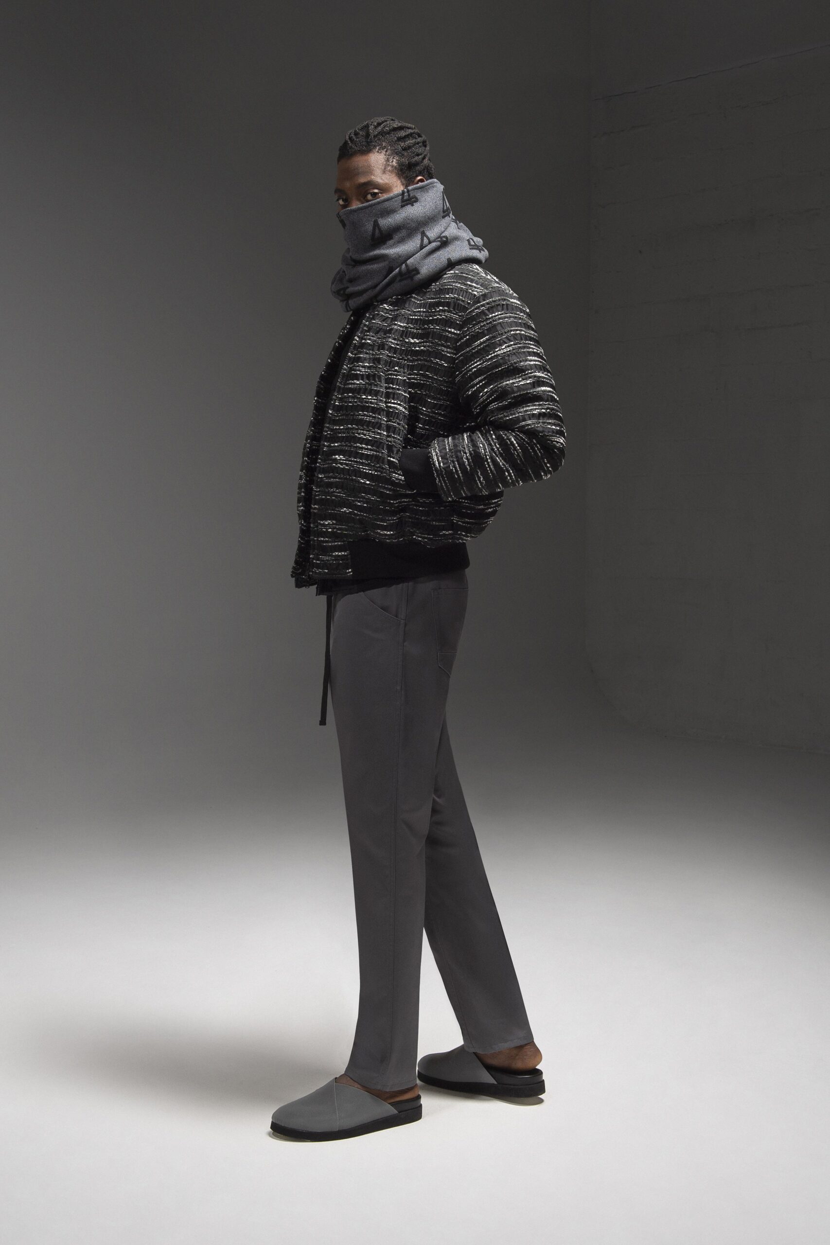 A relaxed black and gray jacket paired with gray pants, featuring a layered design.