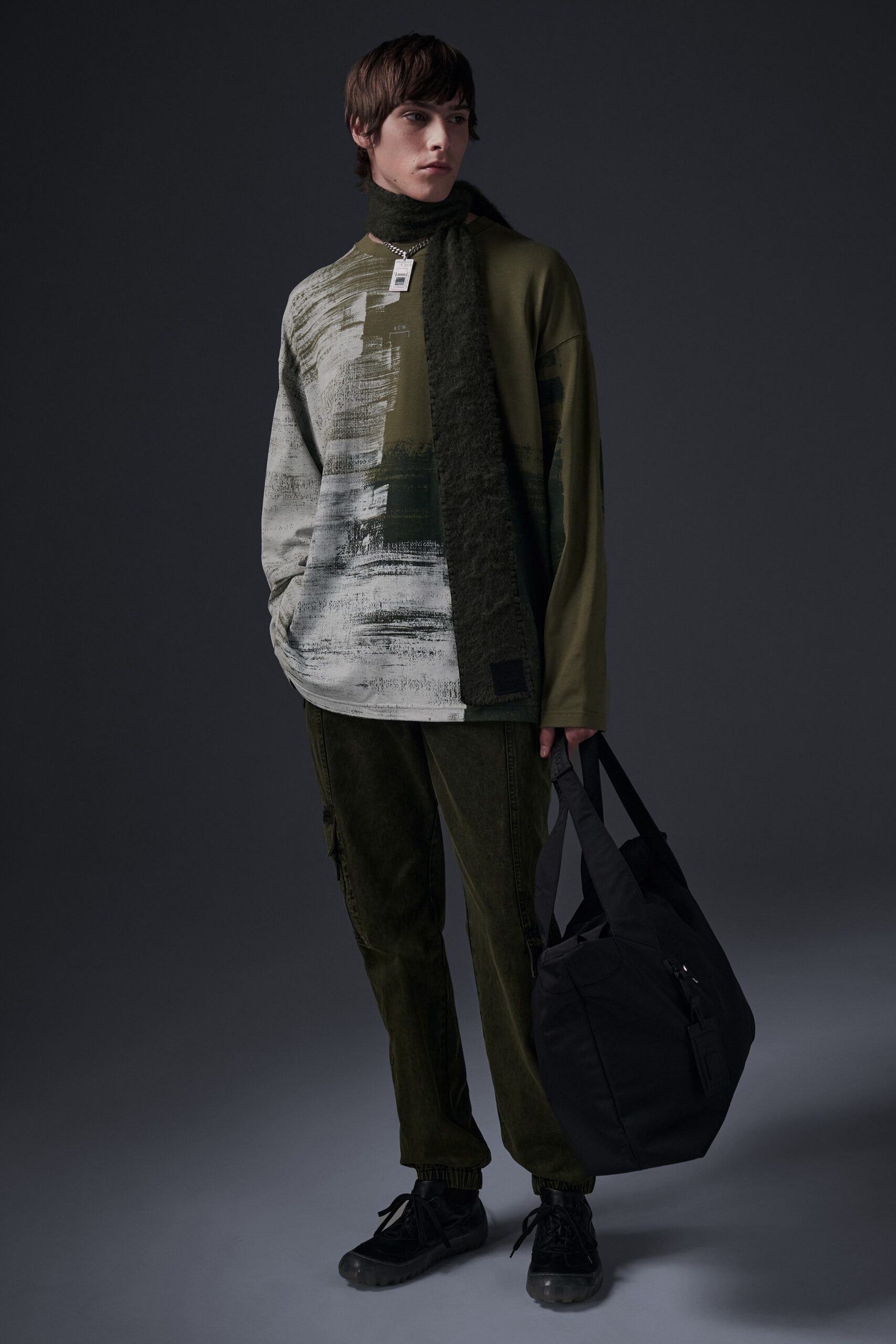 A relaxed green printed top paired with black velvet pants, creating a stylish look.