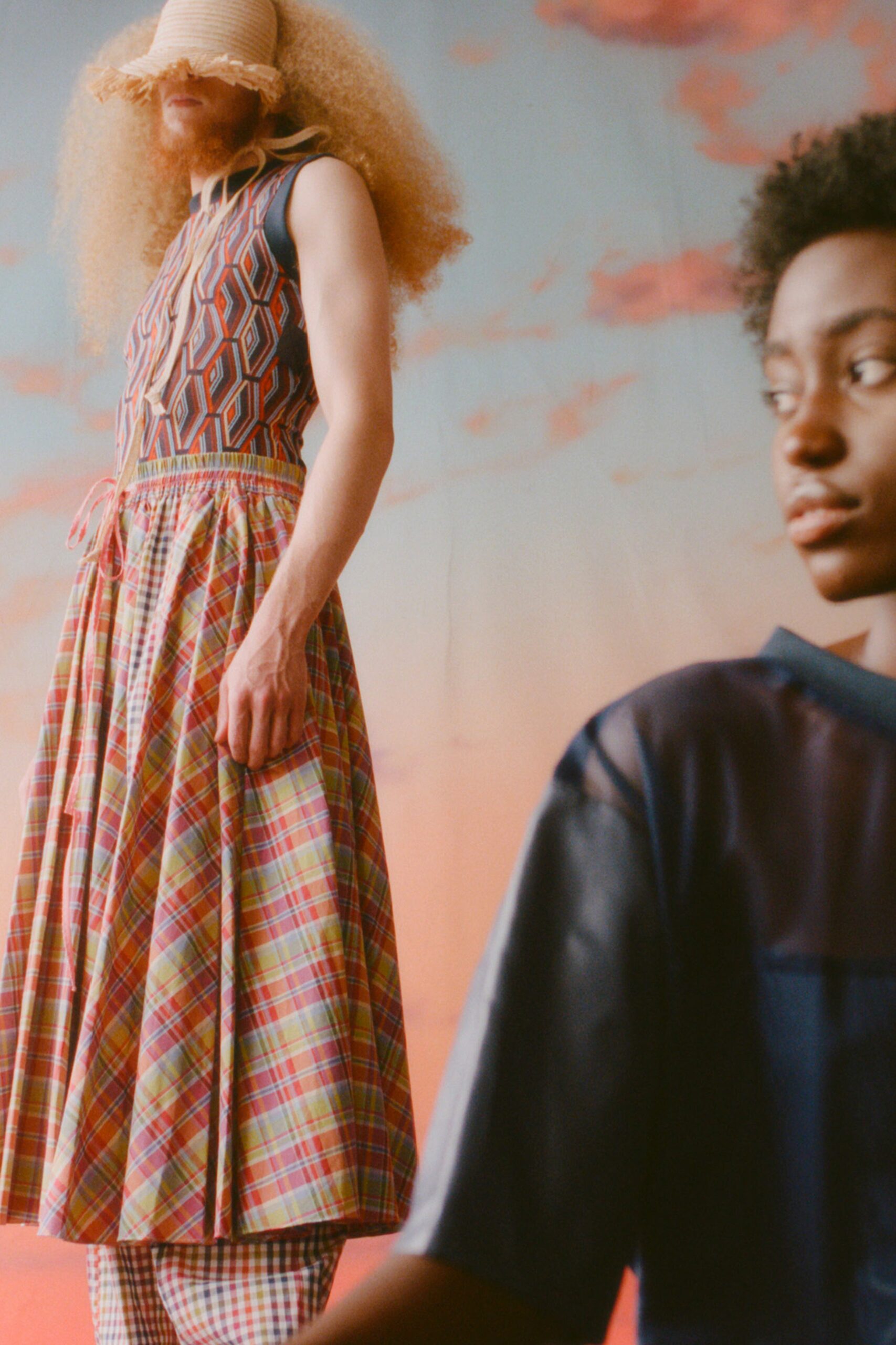 This relaxed sleeveless dress showcases a vibrant mix of patterns, featuring a pleated design that adds depth and movement. The layered construction enhances its playful silhouette, creating a dynamic visual experience that captures attention.