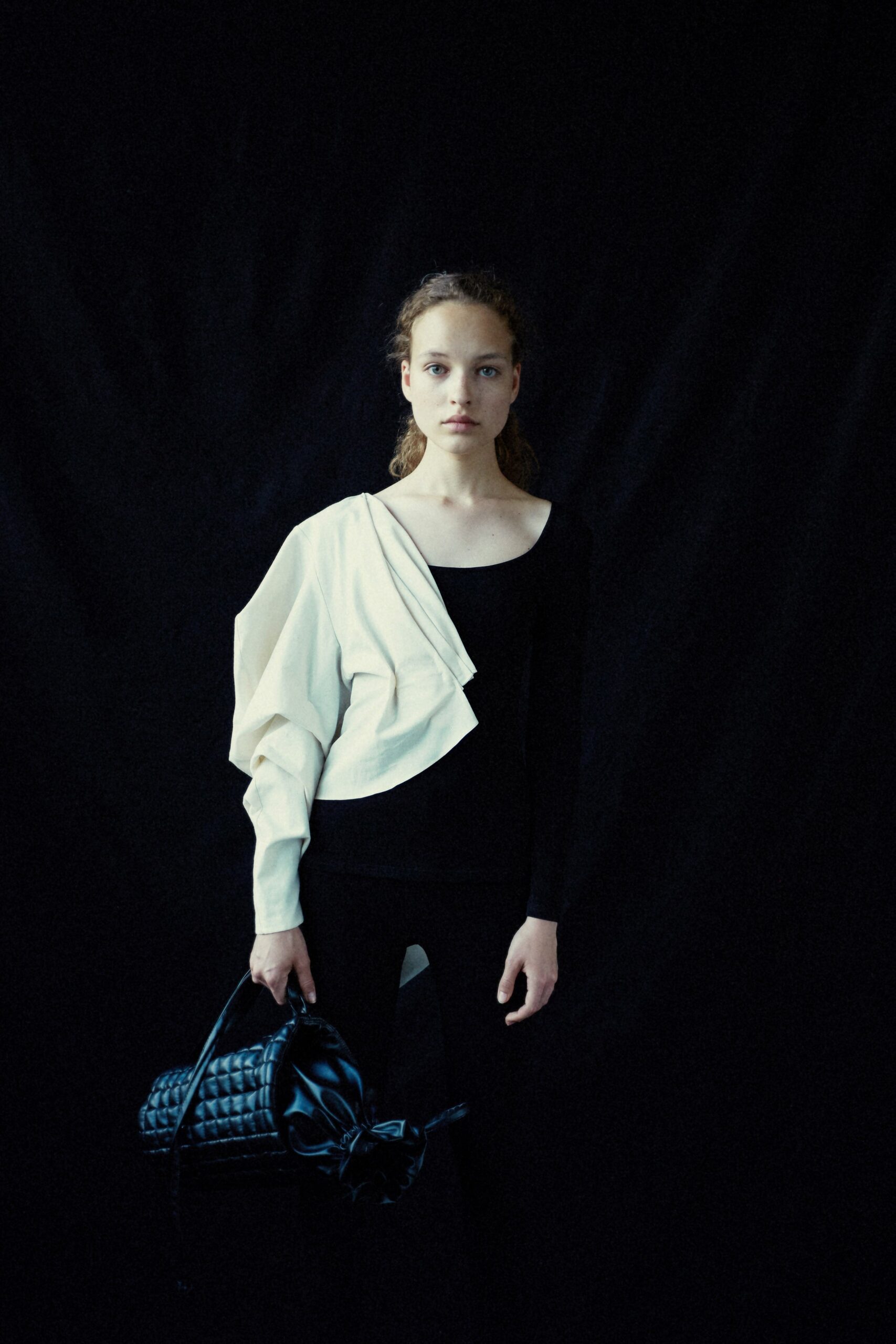 black fitted top with white draped jacket