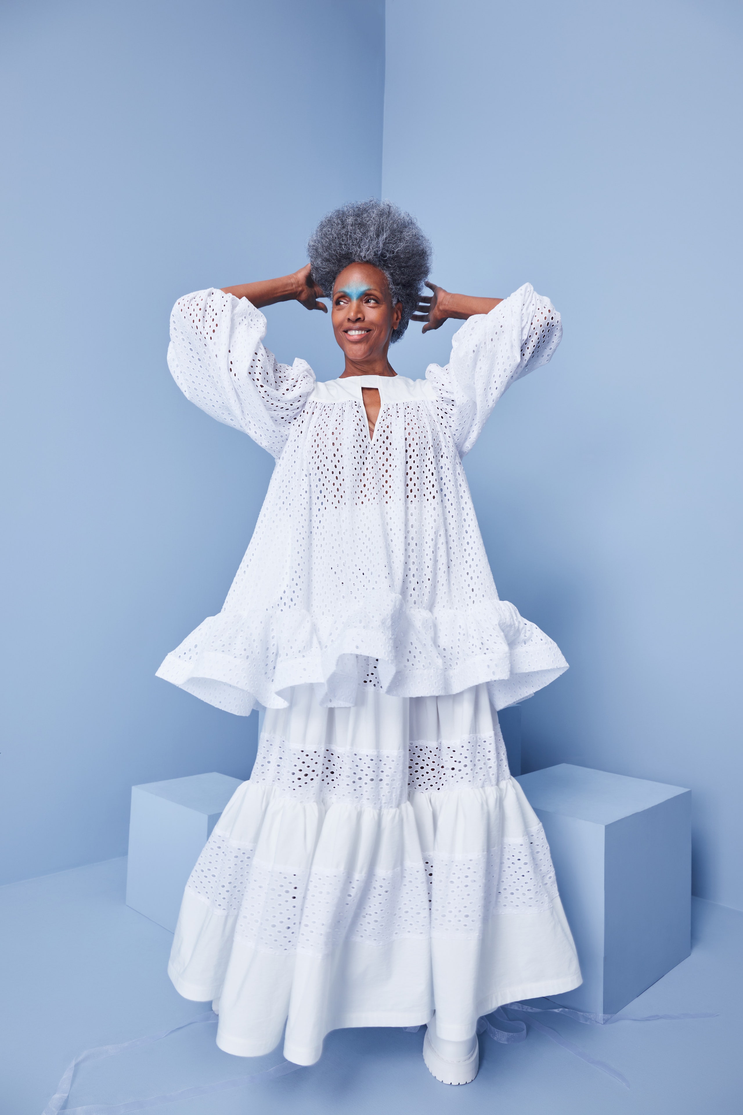 This relaxed dress features a tiered silhouette that adds volume and movement, crafted from breathable cotton. The long sleeves and collared neckline enhance its playful yet sophisticated aesthetic, making it a standout piece for any occasion.