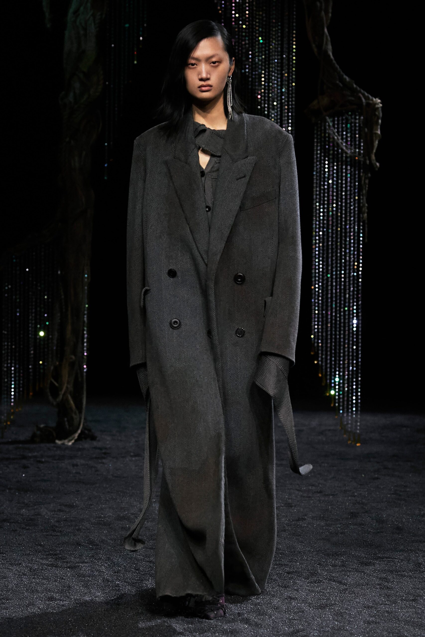 An oversized gray wool coat with long sleeves and wide-leg pants.