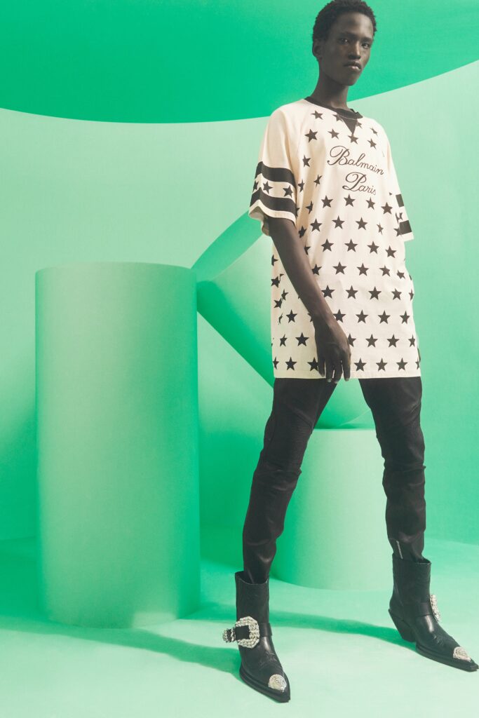A white long-sleeve t-shirt with a star print paired with fitted black pants.