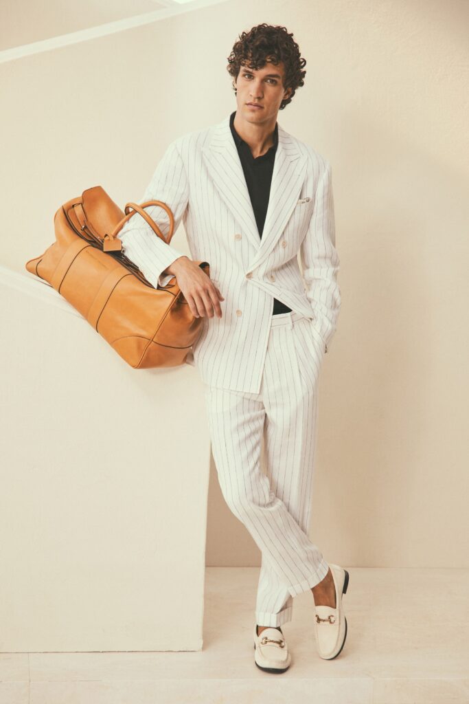 A tailored striped white suit with long sleeves and a collared shirt underneath.