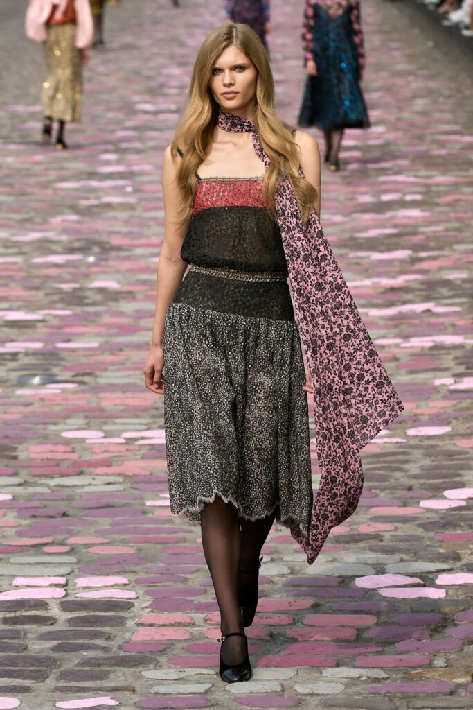 A fitted black and pink layered dress with a strapless design and flared silhouette.