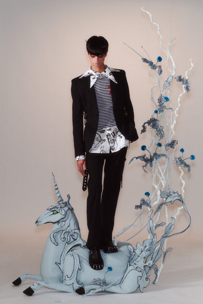 A fitted black and white jacket with a collared long-sleeve shirt featuring stripes and prints.