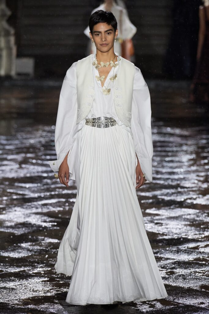 white pleated gown with cape