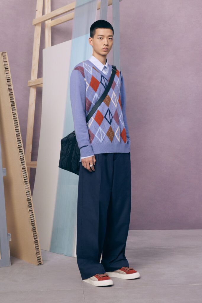 An oversized blue cotton sweater paired with gray wide-leg pants for a relaxed look.