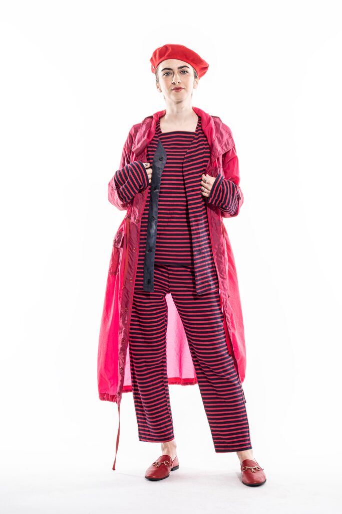 A relaxed red coat with long sleeves and striped pants, perfect for a bold fashion statement.