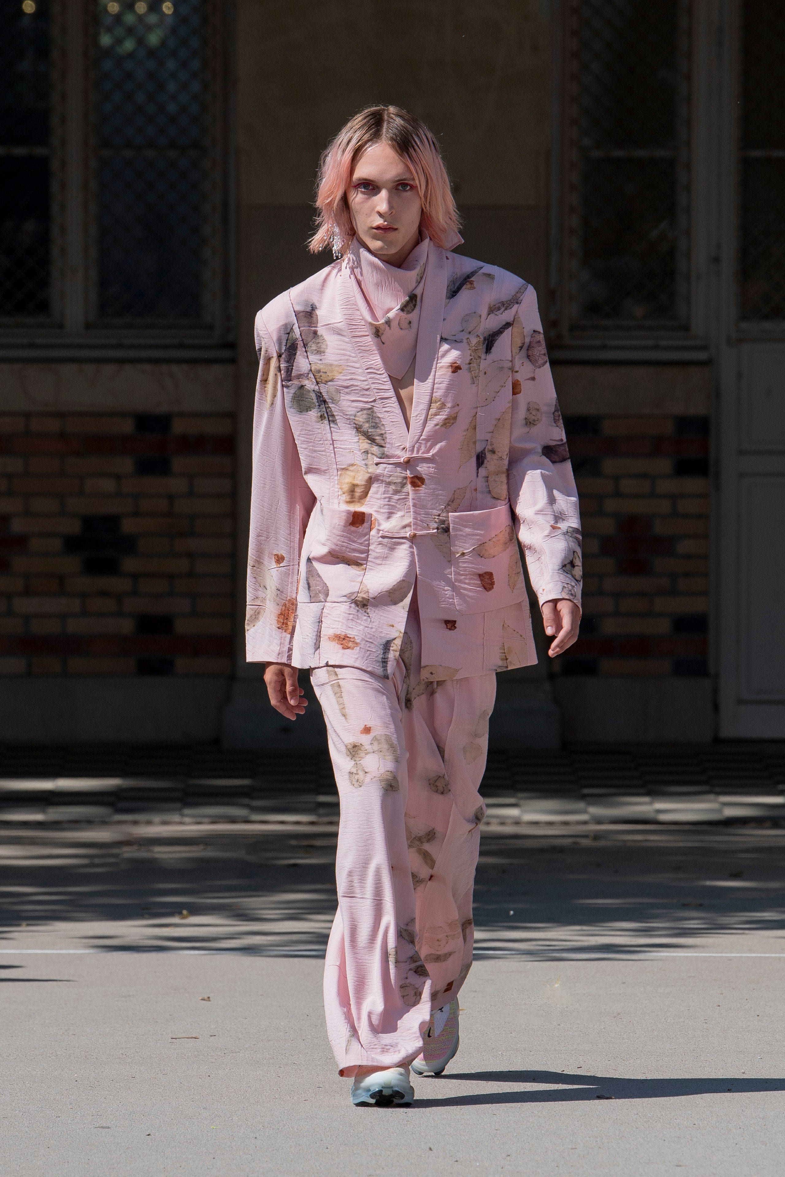 A tailored pink suit with a long-sleeve collared jacket and printed design.